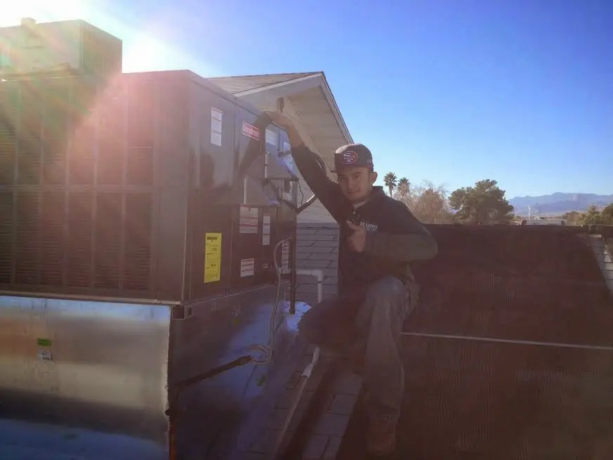 HVAC technician performing Air Duct Repair on a rooftop unit in Plumstead